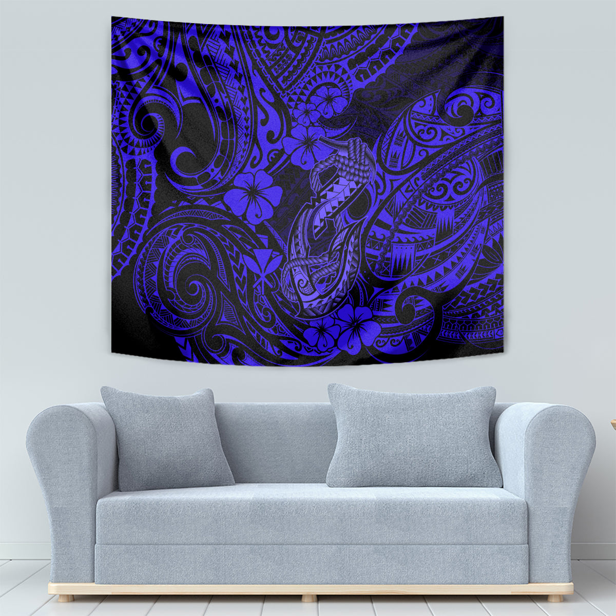 Navy blue Polynesian fish hook tapestry on a wall with ornate swirls and hibiscus blossoms