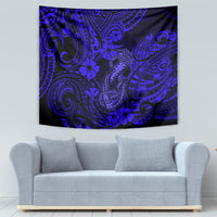 Navy blue Polynesian fish hook tapestry on a wall with ornate swirls and hibiscus blossoms