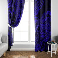 Pair of navy blue patterned window curtains hanging on either side of a white door