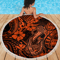 Orange circular beach blanket with black Polynesian design and white tassel fringe border