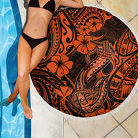 Orange circular beach blanket with black Polynesian print and white fringe border, close