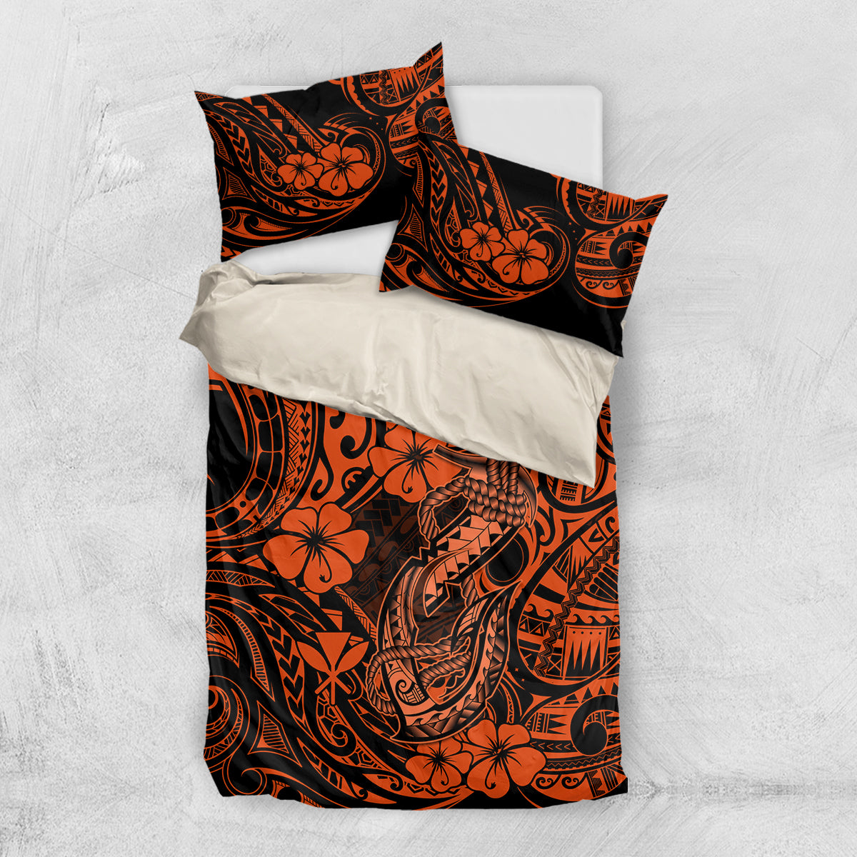 Orange and black Polynesian pattern duvet with two pillowcases, flat lay