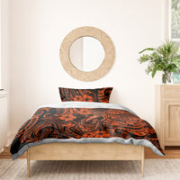 Orange and black Polynesian pattern duvet and pillowcase set on wooden bed