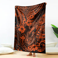 Orange and black fish hook patterned blanket standing upright with floral motifs
