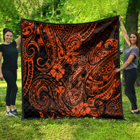 Orange and black Polynesian-pattern quilt draped outdoors, featuring swirling motifs