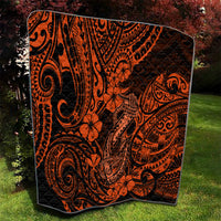 Orange and black Polynesian-pattern quilt with floral accents and spiral designs