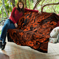 Orange and black Polynesian-pattern quilt laid out, with tiki swirls and flowers