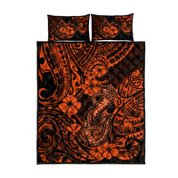 Orange and black quilt bed set laid flat, with two pillow covers and duvet