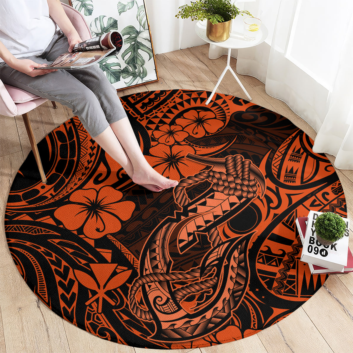 Orange round carpet with Polynesian fish hook motif, tribal symbols, and black accents.