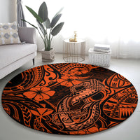 Orange round carpet featuring Polynesian fish hook pattern with floral and tribal details.