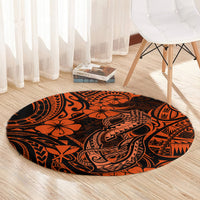 Orange round carpet with Polynesian fish hook pattern, tribal lines, and black motifs.