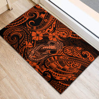 Orange and black Polynesian patterned rubber doormat with ornate tiki motifs