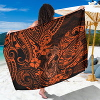 Orange and black polynesian-pattern sarong with hibiscus and scroll motifs, draped