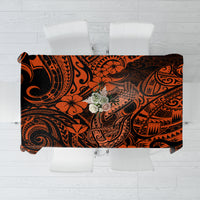 Orange and black Polynesian-style tablecloth with fish hook and floral motifs