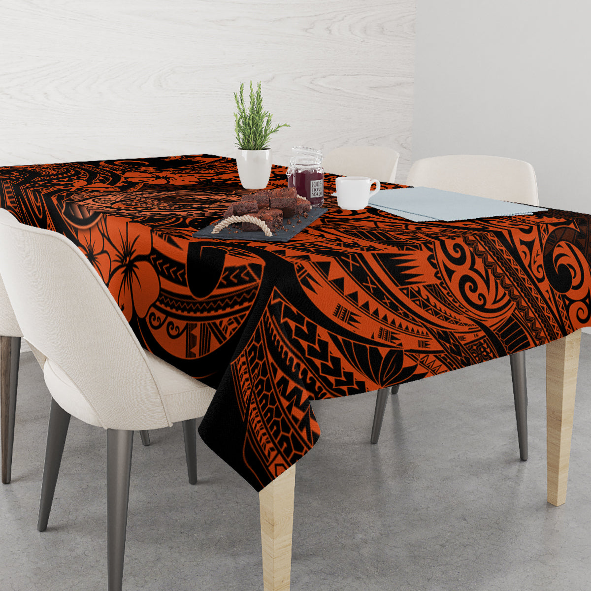 Orange and black Polynesian pattern tablecloth with fish hook and wave motifs