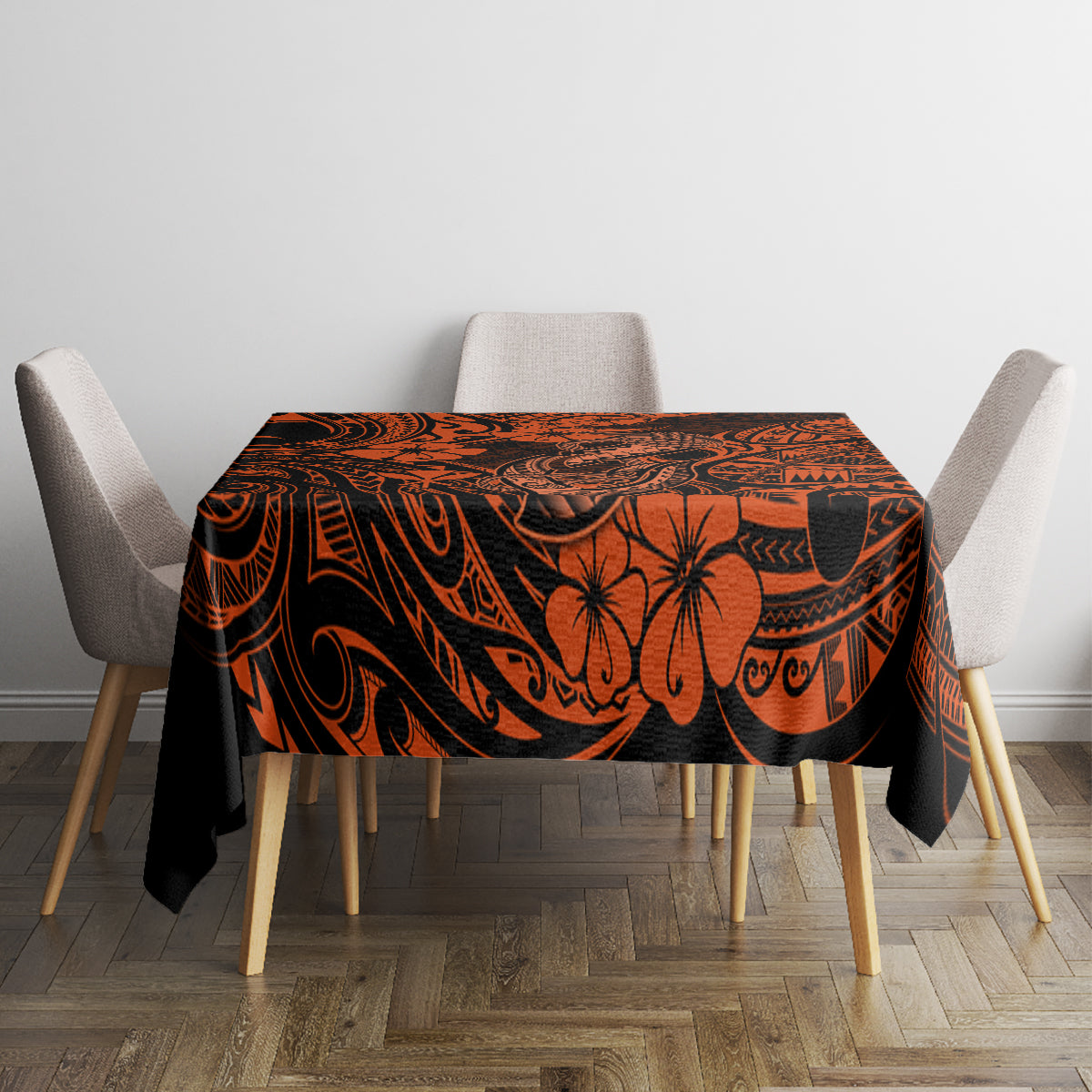 Orange and black patterned tablecloth with central floral and hook motifs on table