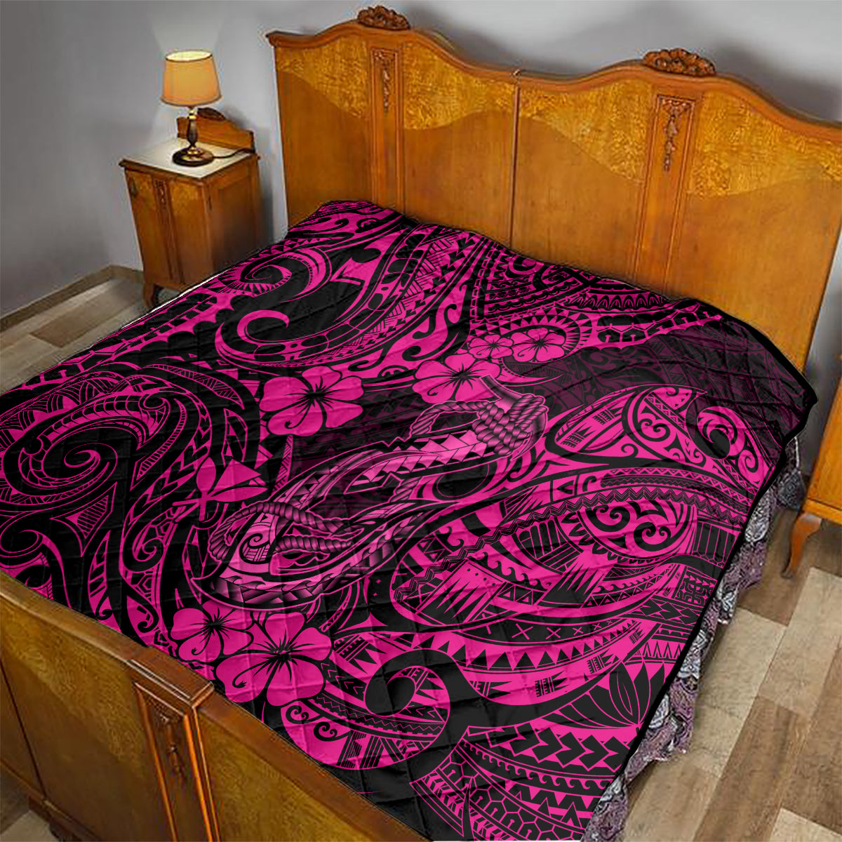 Pink and black Hawaii fish hook quilt with hibiscus flowers over bed