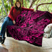 Pink and black Hawaii fish hook quilt with hibiscus tribal design draped on couch