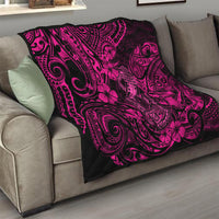 Pink and black Hawaii fish hook quilt with hibiscus floral tribal pattern on sofa