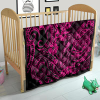 Pink and black Hawaii fish hook quilt with hibiscus tribal design on baby bed