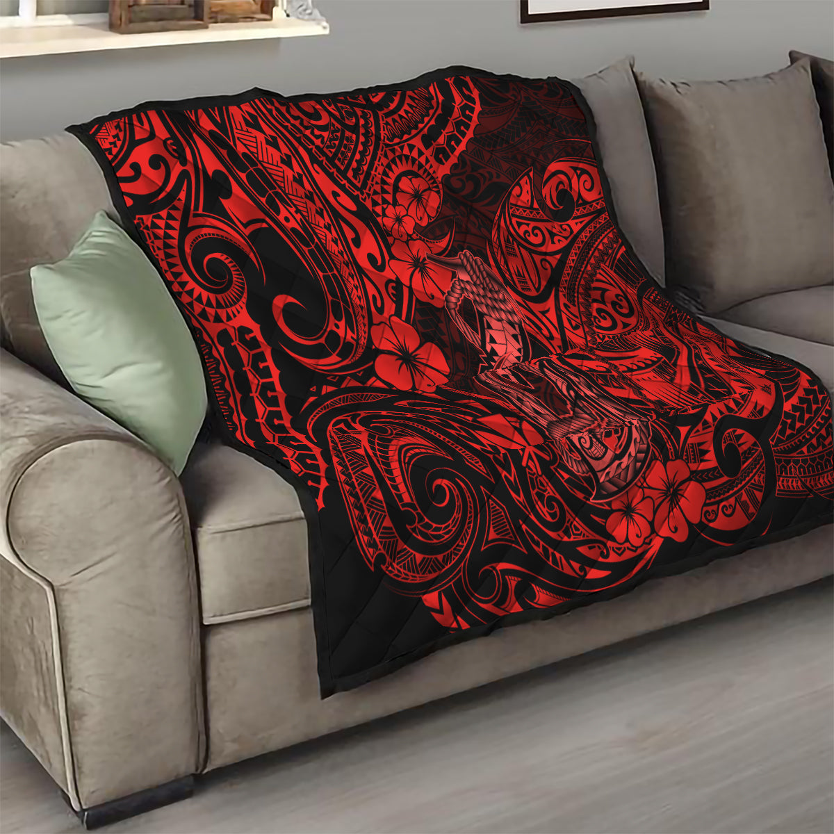 Red and black quilt blanket with tribal tattoo swirls, hibiscus flowers, and fish hook motifs