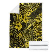 Yellow and dark hibiscus fishhook tribal throw blanket shown folded, with rolled towels