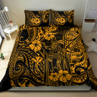 Gold and black Polynesian-style bedding set, duvet cover with two pillow shams on bed