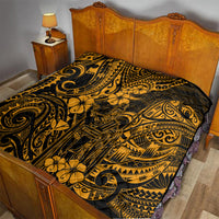Gold Polynesian-pattern quilt spread on a bed with black base and detailed swirl-and-flower design