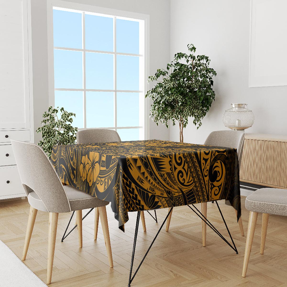 Gold and black Polynesian tablecloth covering a dining table with chair placement visible.