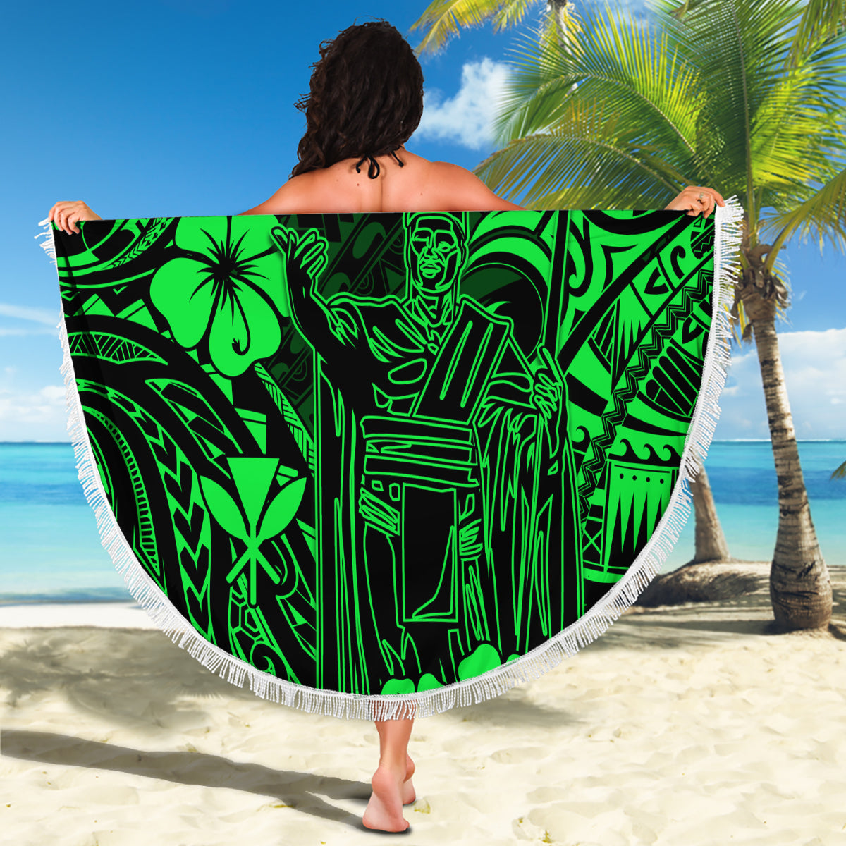 Green round beach blanket with bold Polynesian graphic and fringed edge, held up