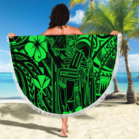 Green round beach blanket with bold Polynesian graphic and fringed edge, held up