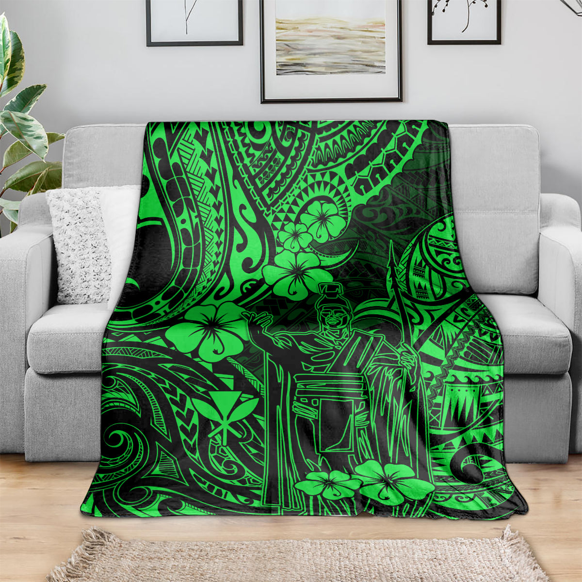 Green Polynesian pattern throw blanket draped over a gray sofa.