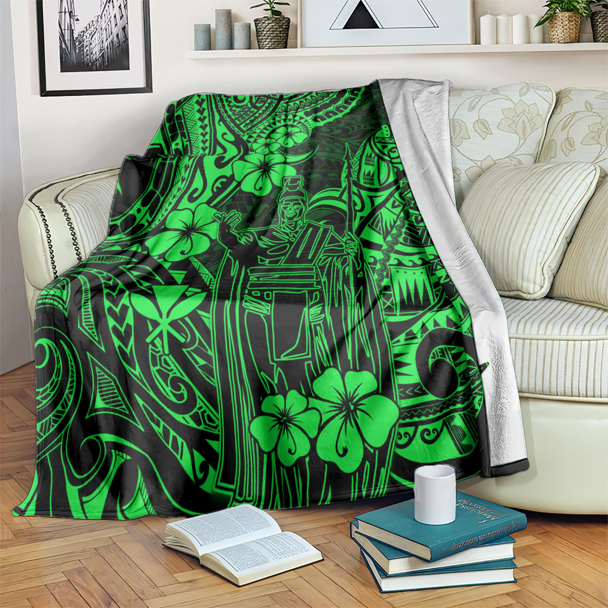 Green Polynesian pattern blanket folded over a couch with books on the floor.