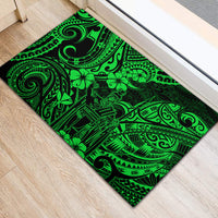 Green rubber doormat with swirling tribal motifs and black outer border, rectangular