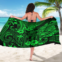 Green polynesian-pattern sarong with tribal motifs, wrapped skirt worn draped over hips