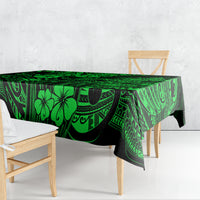 Green polynesian tablecloth draped over table with swirling geometric and leaf motifs