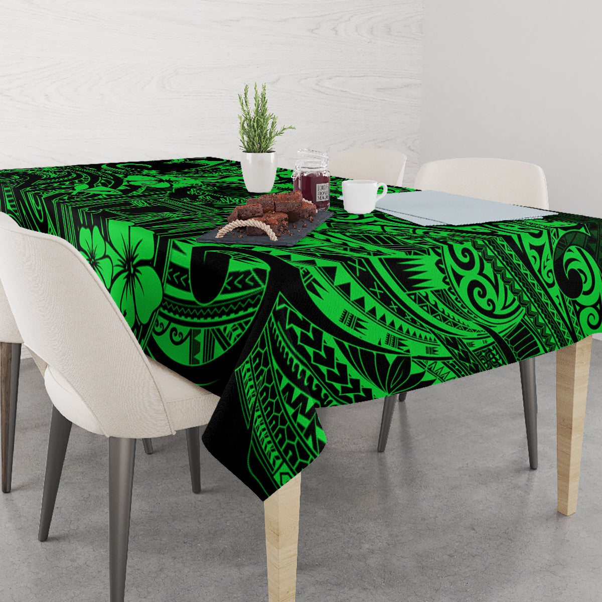 Green polynesian tablecloth on dining table, featuring geometric borders and flower shapes