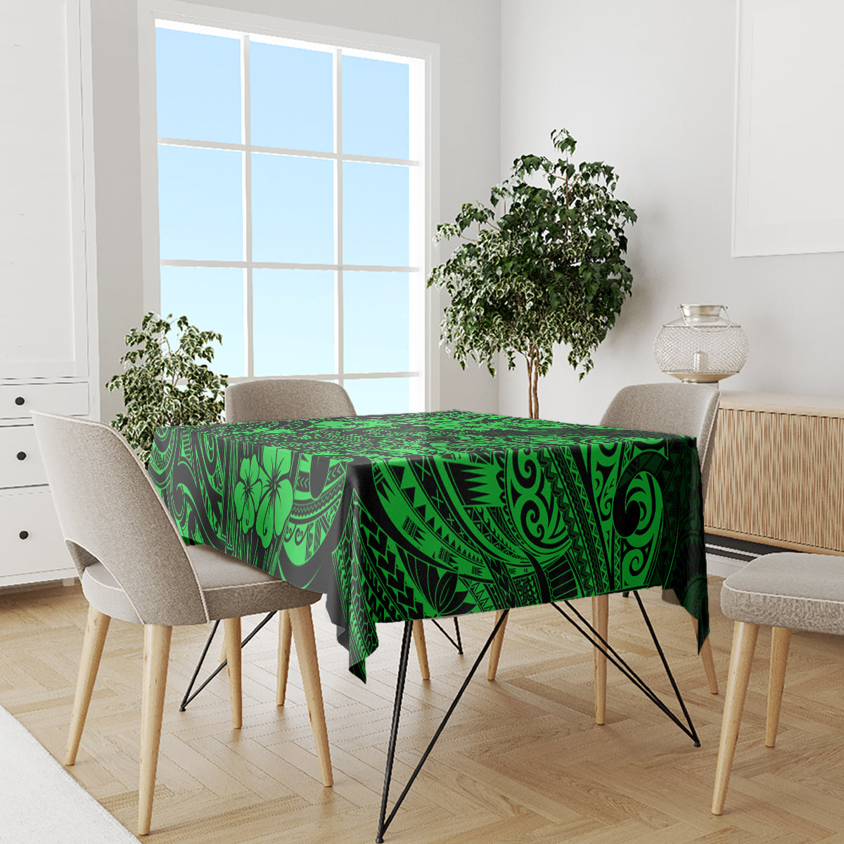 Green polynesian tablecloth covering table with matching border and leaf-and-arch pattern