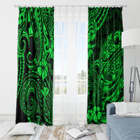 Green Polynesian motif window curtain panels with hanging rod above sheer light