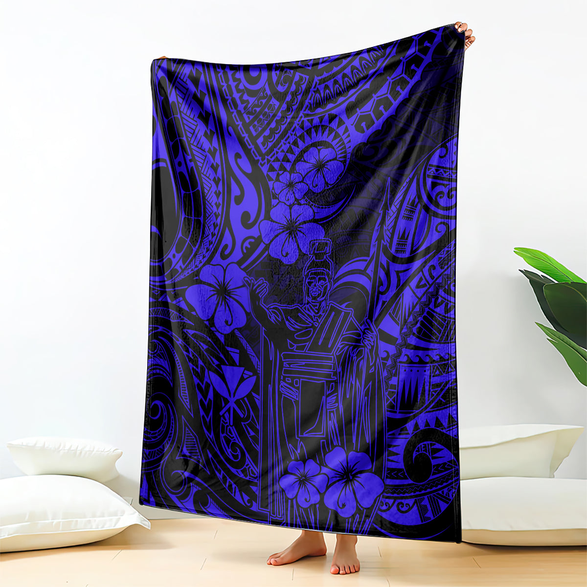 Navy blue Polynesian pattern blanket with hibiscus and geometric tiki motifs, draped on bed