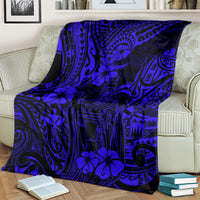 Navy blue Polynesian pattern throw blanket with hibiscus and tribal lines, over an armchair