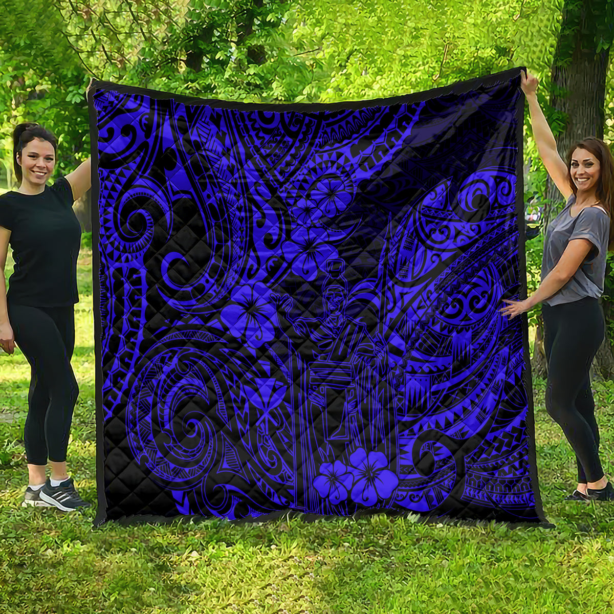 Navy blue and black Polynesian patterned quilt blanket with ornate swirls and flowers