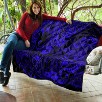 Polynesian-style quilt blanket in dark navy and black with swirl and hibiscus-like flowers