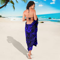 Navy blue polynesian-pattern sarong with swirls and hibiscus, tied at back waist