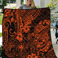 Orange and black Polynesian-style quilt with swirling tiki and floral motifs