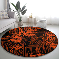 Round orange and black Polynesian patterned rug featuring tiki figures and geometric motifs