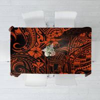 Orange and black Polynesian patterned tablecloth with decorative center floral