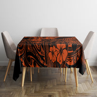 Orange and black Polynesian patterned tablecloth centered on dining table