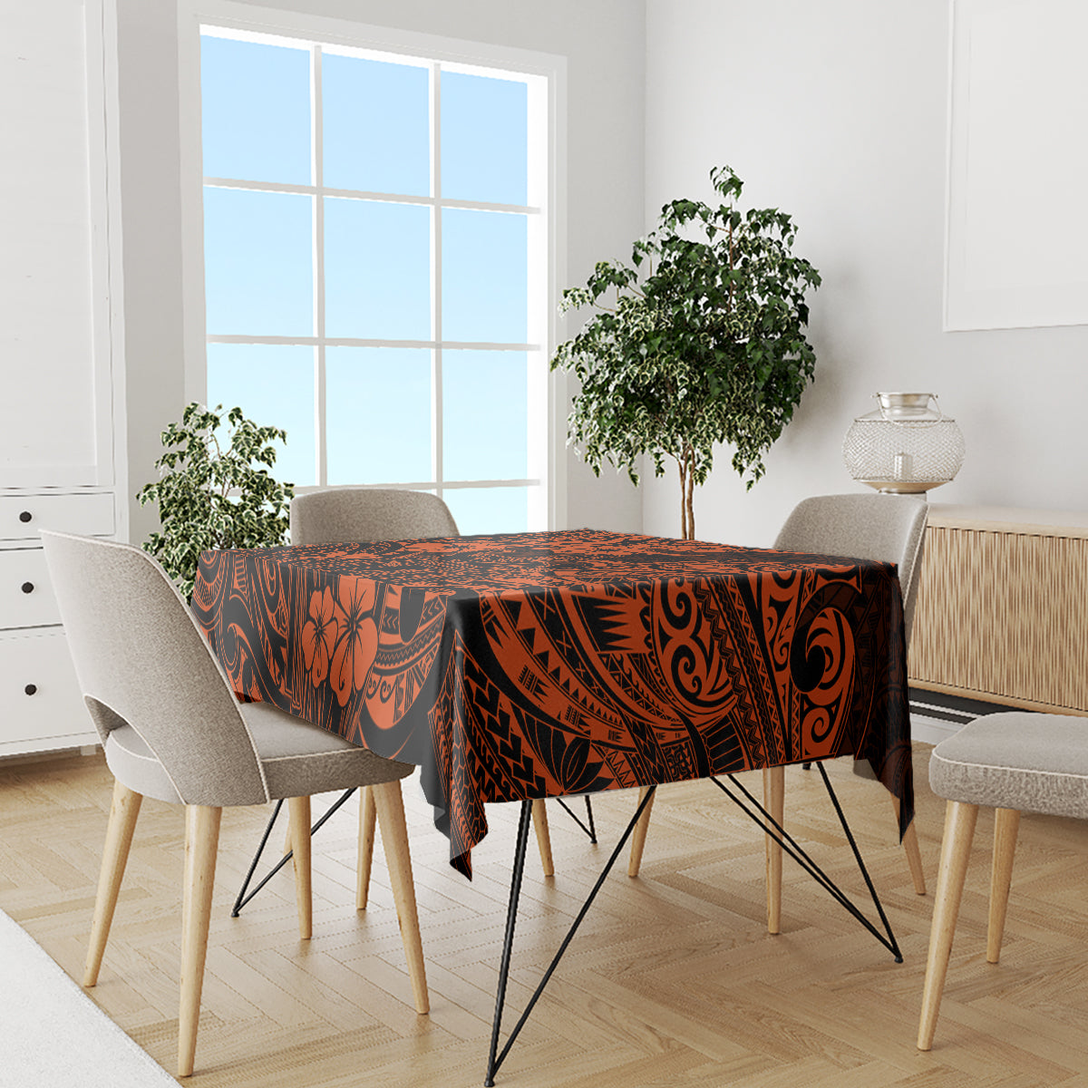 Orange and black Polynesian patterned tablecloth on modern dining set