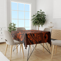 Orange and black Polynesian patterned tablecloth on modern dining set